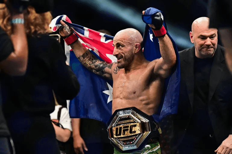 Australia’s Alexander Volkanovski celebrates retaining his UFC featherweight title after defeating Russia’s Movsar Evloev by second-round TKO at UFC 333 in Abu Dhabi.